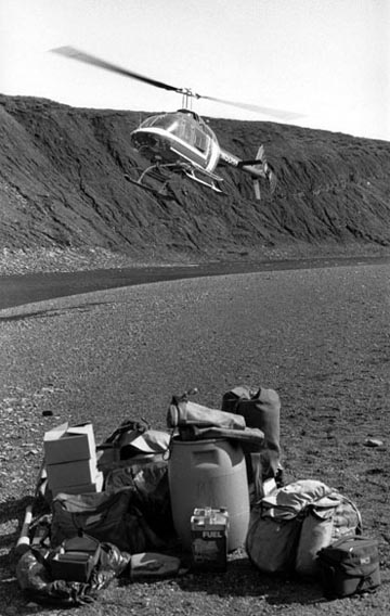 Field photograph of field equipment and helicopter leaving at the start of fieldwork in 1996
