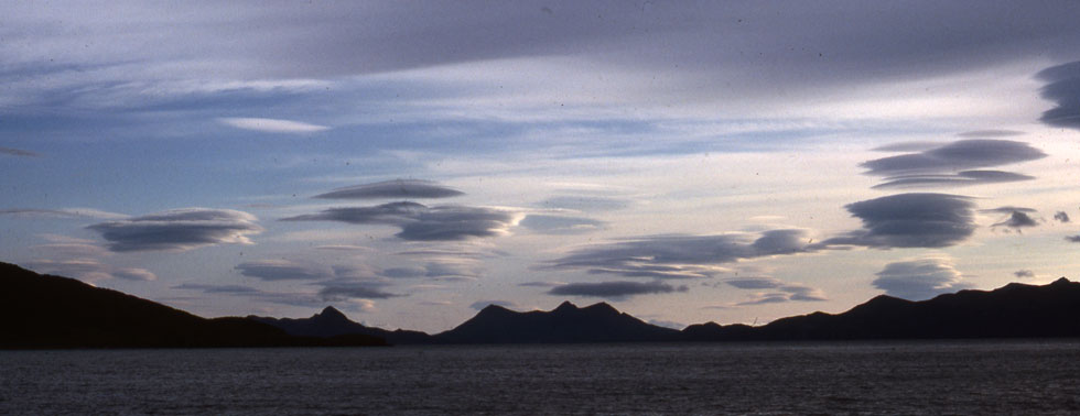 Photograph of lenticular clouds over the mountains of the Alaska Peninsula